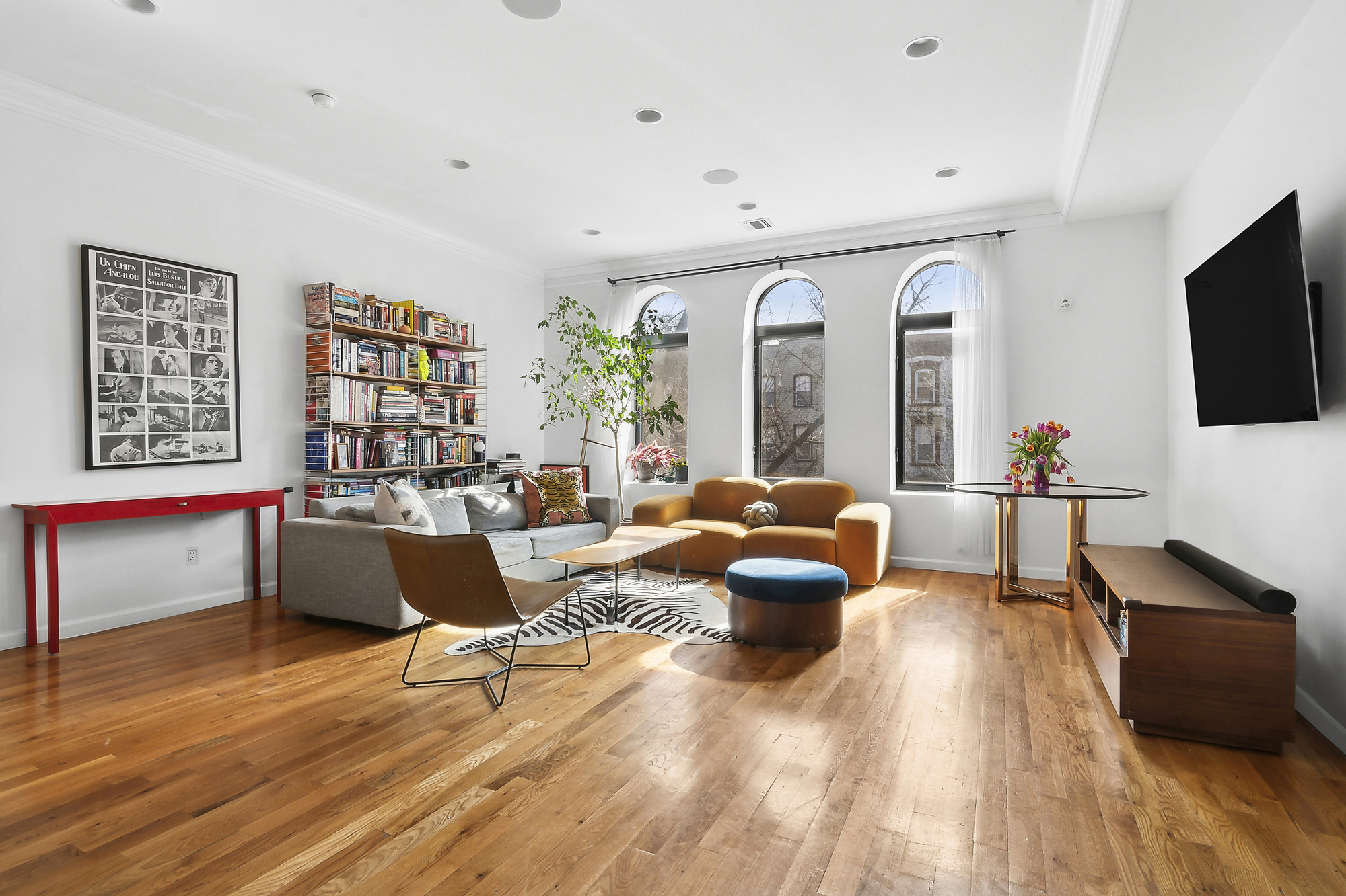 147 Herkimer Street Brooklyn, NY 11216 - Photo 18 of 25 a living room with furniture and a flat screen tv