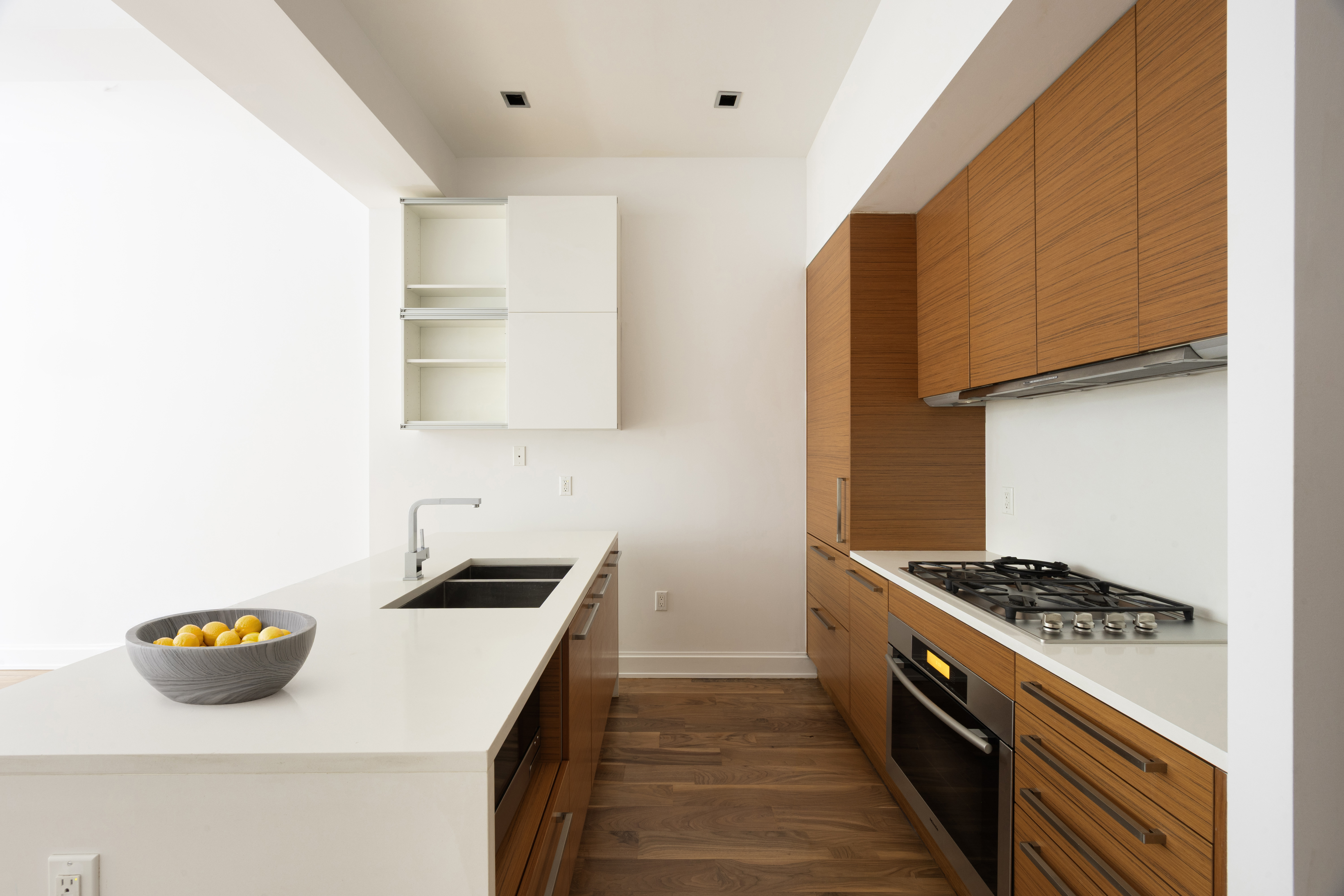 140 West 22nd Street, Unit 2B Manhattan, NY 10011 - Photo 5 of 12 a kitchen with a sink a stove and cabinets