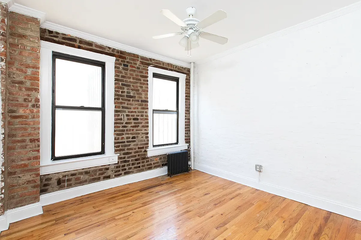 649 East 9th Street, Unit D3 Manhattan, NY 10009 - Photo 3 of 5 an empty room with wooden floor and windows