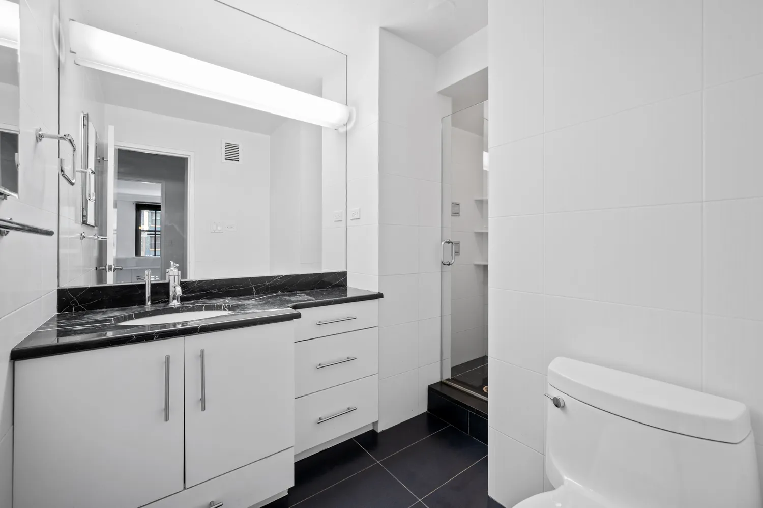 a bathroom with a granite countertop sink a toilet and a mirror