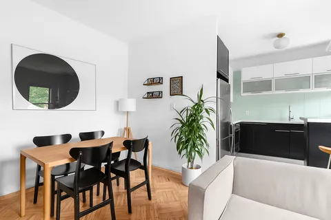 a dining room with furniture and a mirror
