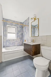 a bathroom with a toilet a sink and bathtub