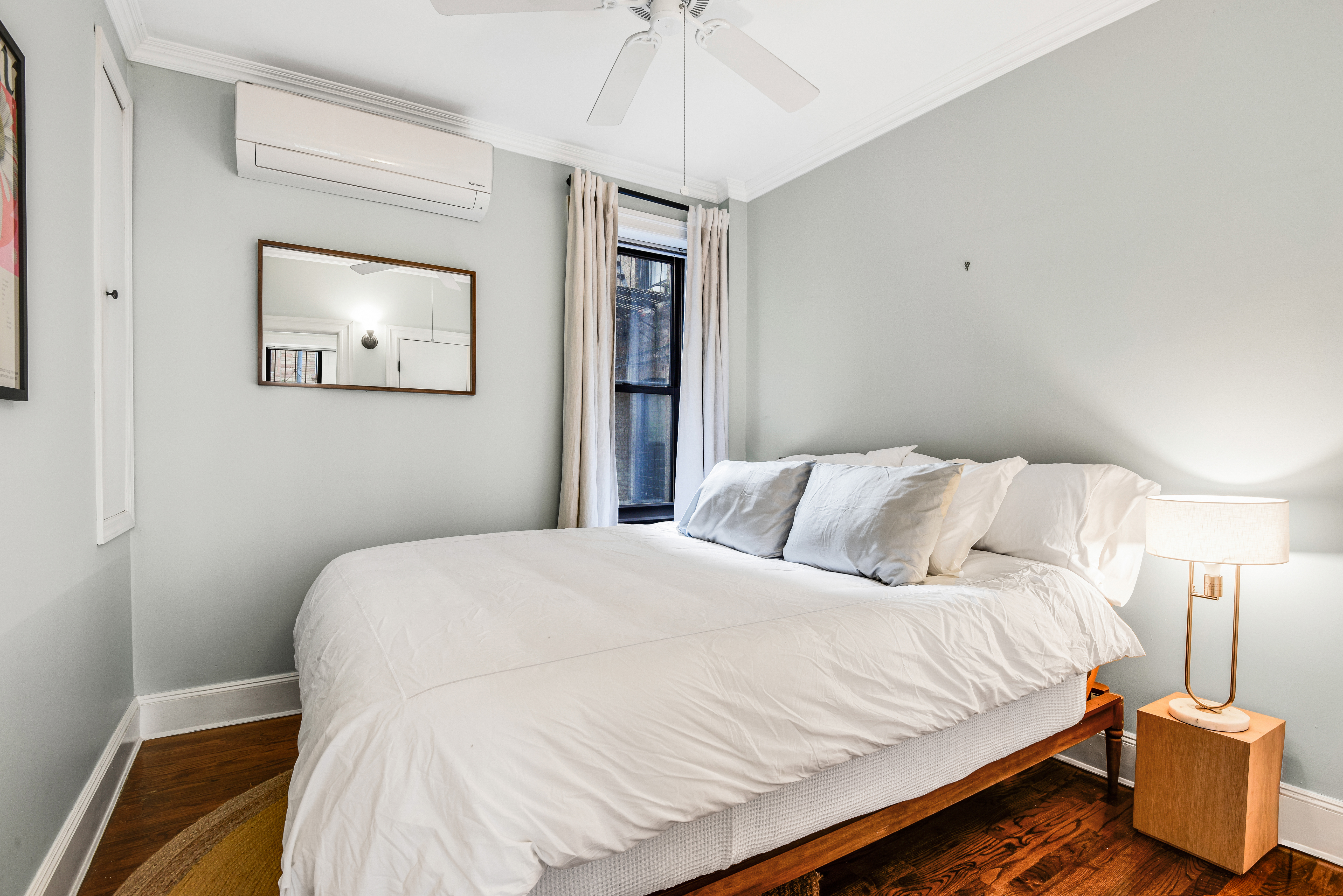 322 6th Street, Unit 2 Brooklyn, NY 11215 - Photo 4 of 11 a bedroom with a bed and a chandelier