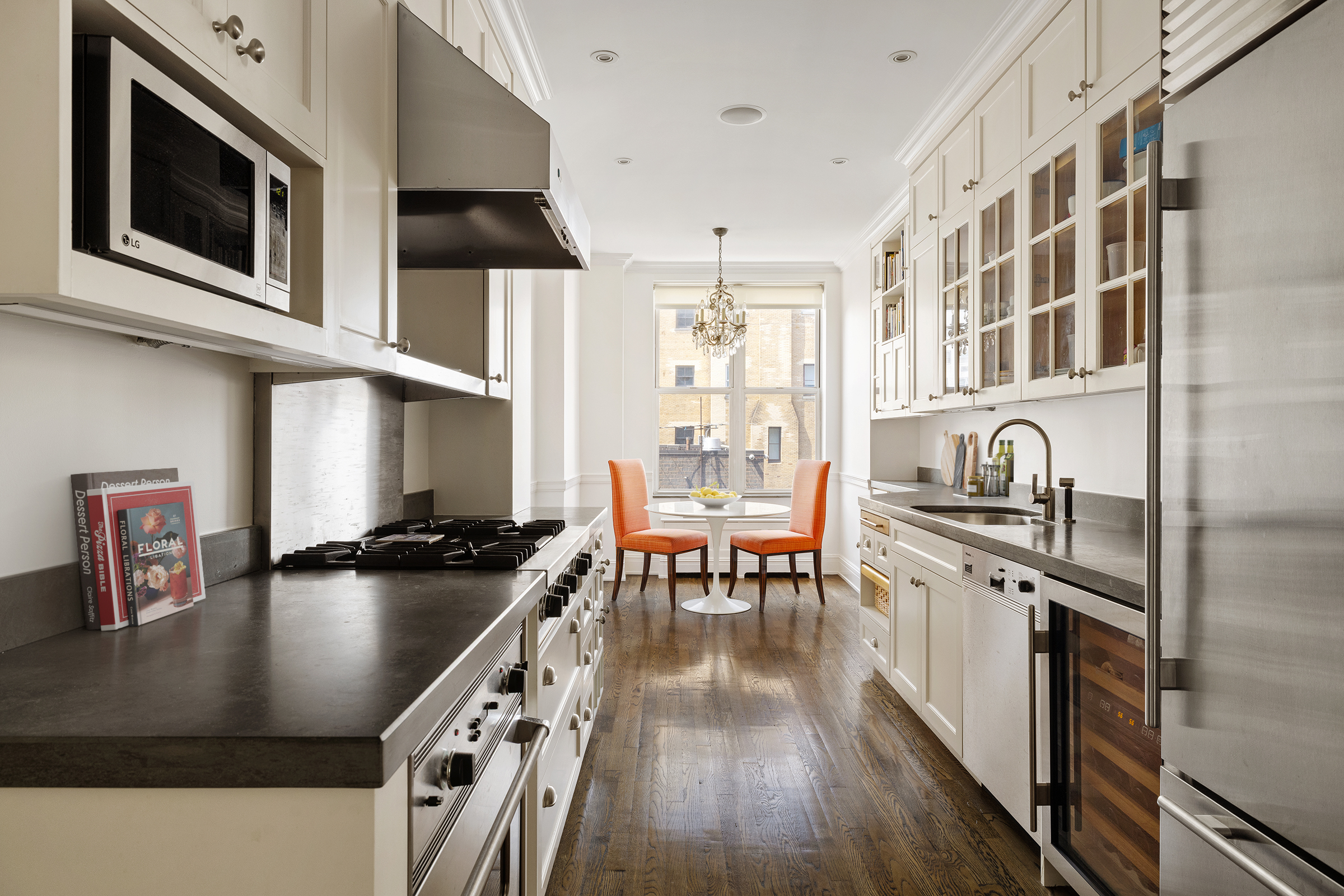 876 Park Avenue, Unit 9N Manhattan, NY 10075 - Photo 6 of 18 a kitchen with stainless steel appliances granite countertop a stove a sink and a microwave