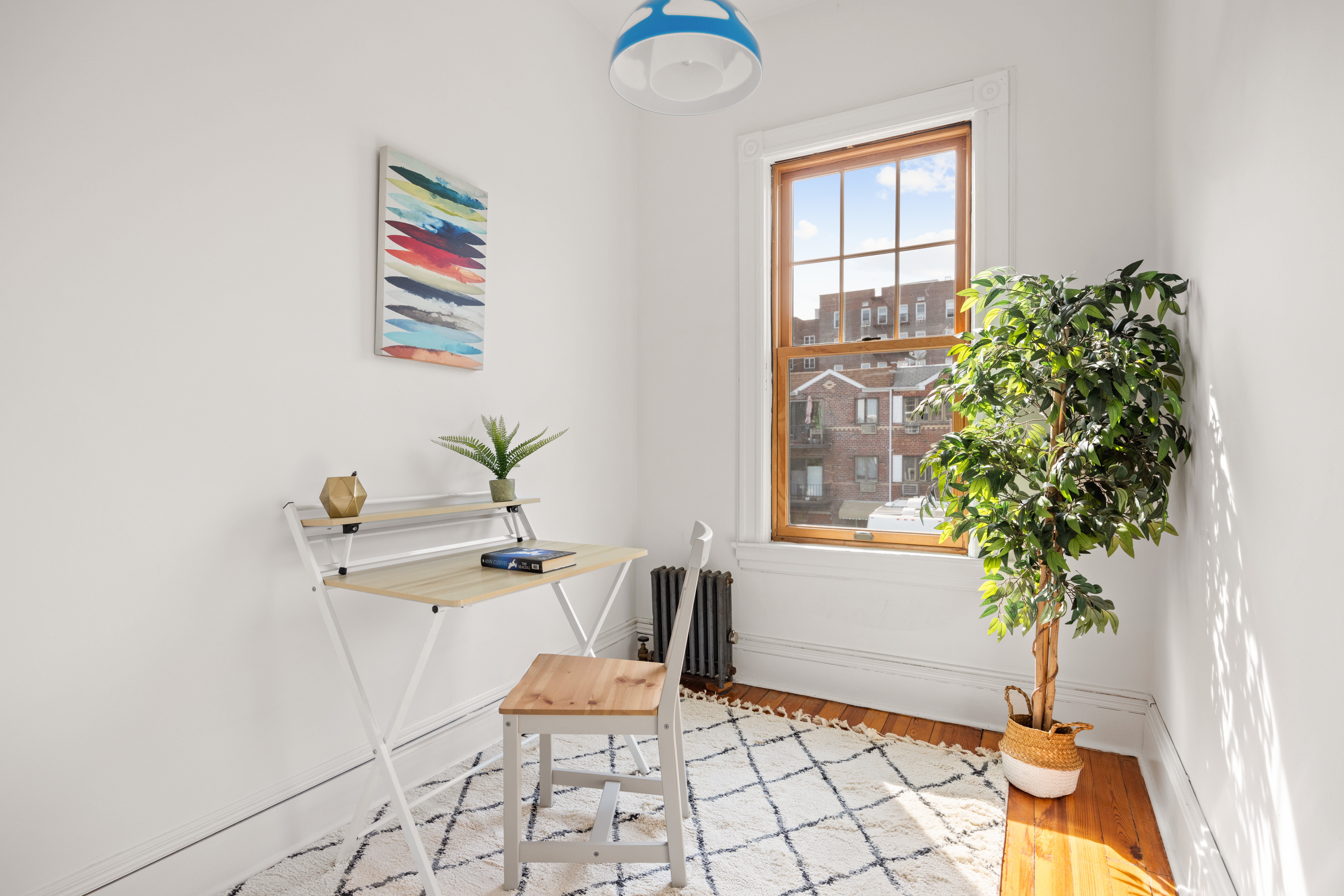 99 East 2nd Street Brooklyn, NY 11218 - Photo 16 of 24 a living room with furniture and a potted plant