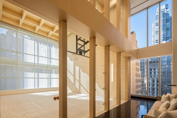 a living room with furniture and floor to ceiling windows