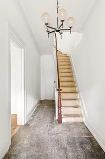 a view of a staircase with white walls