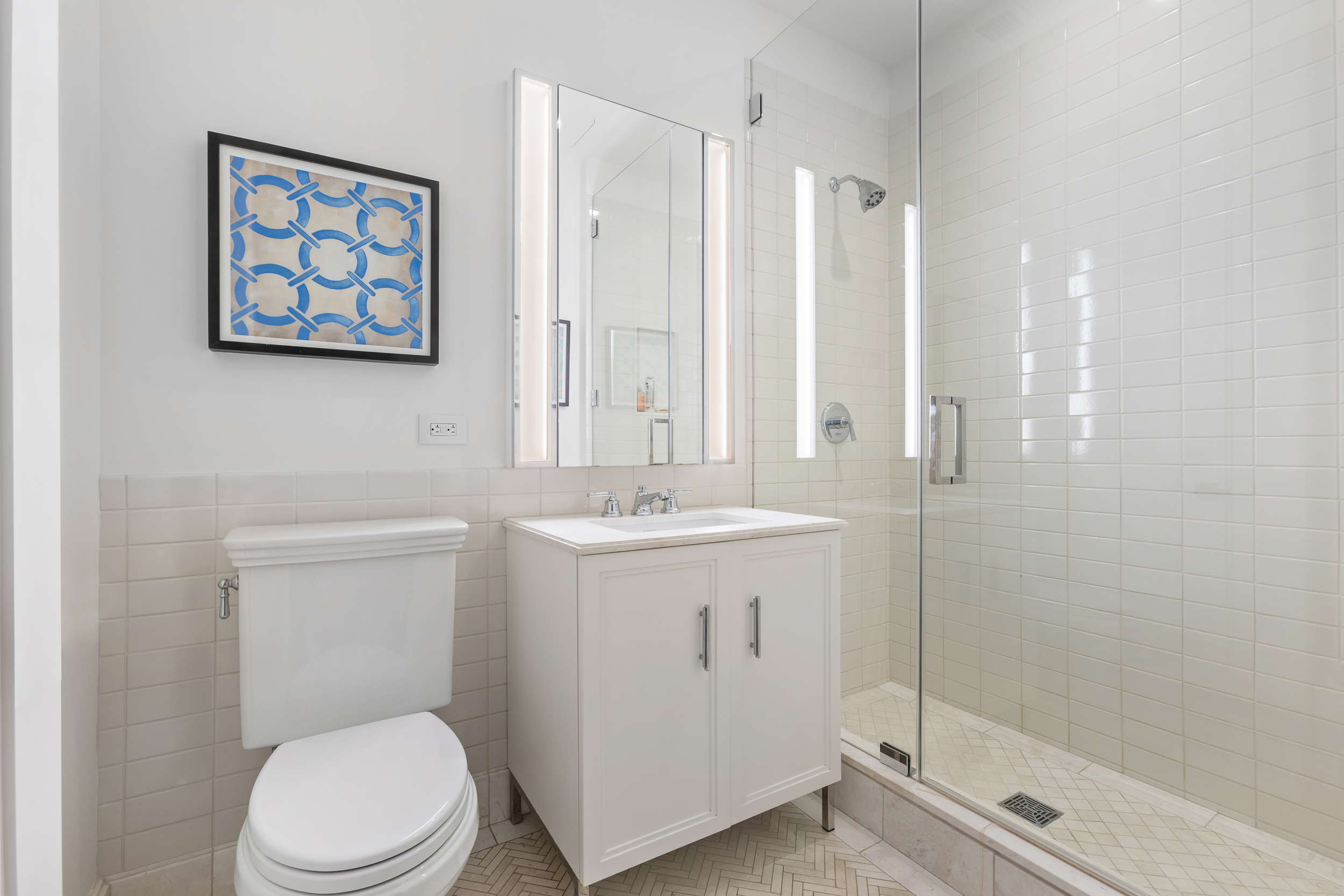 100 Barclay Street, Unit 17A Manhattan, NY 10007 - Photo 12 of 24 a bathroom with a toilet a sink and mirror