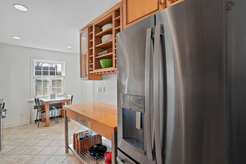 a open kitchen with stainless steel appliances granite countertop a stove and a refrigerator