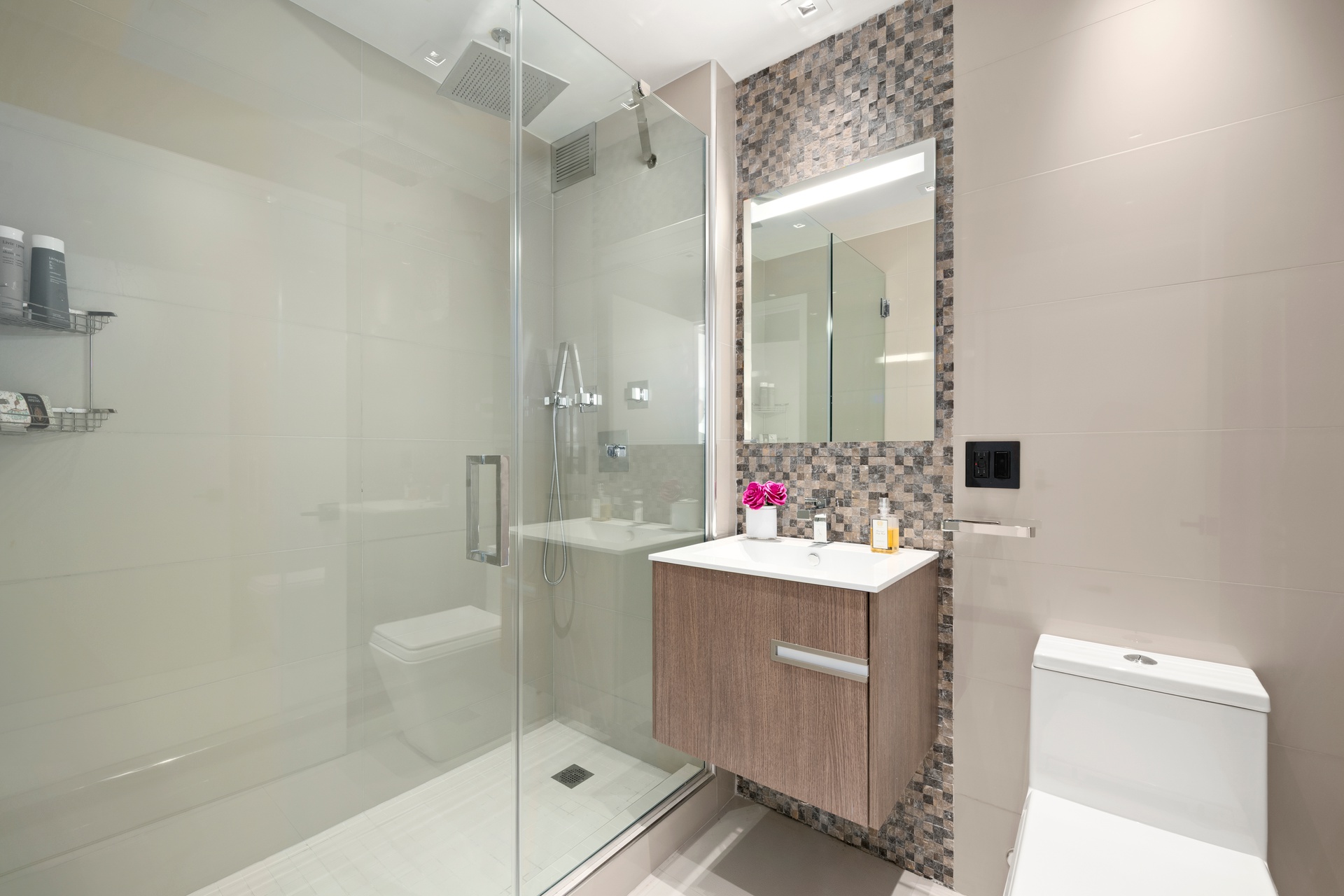 22 West 15th Street, Unit 19D Manhattan, NY 10011 - Photo 11 of 18 a bathroom with a sink mirror toilet and shower