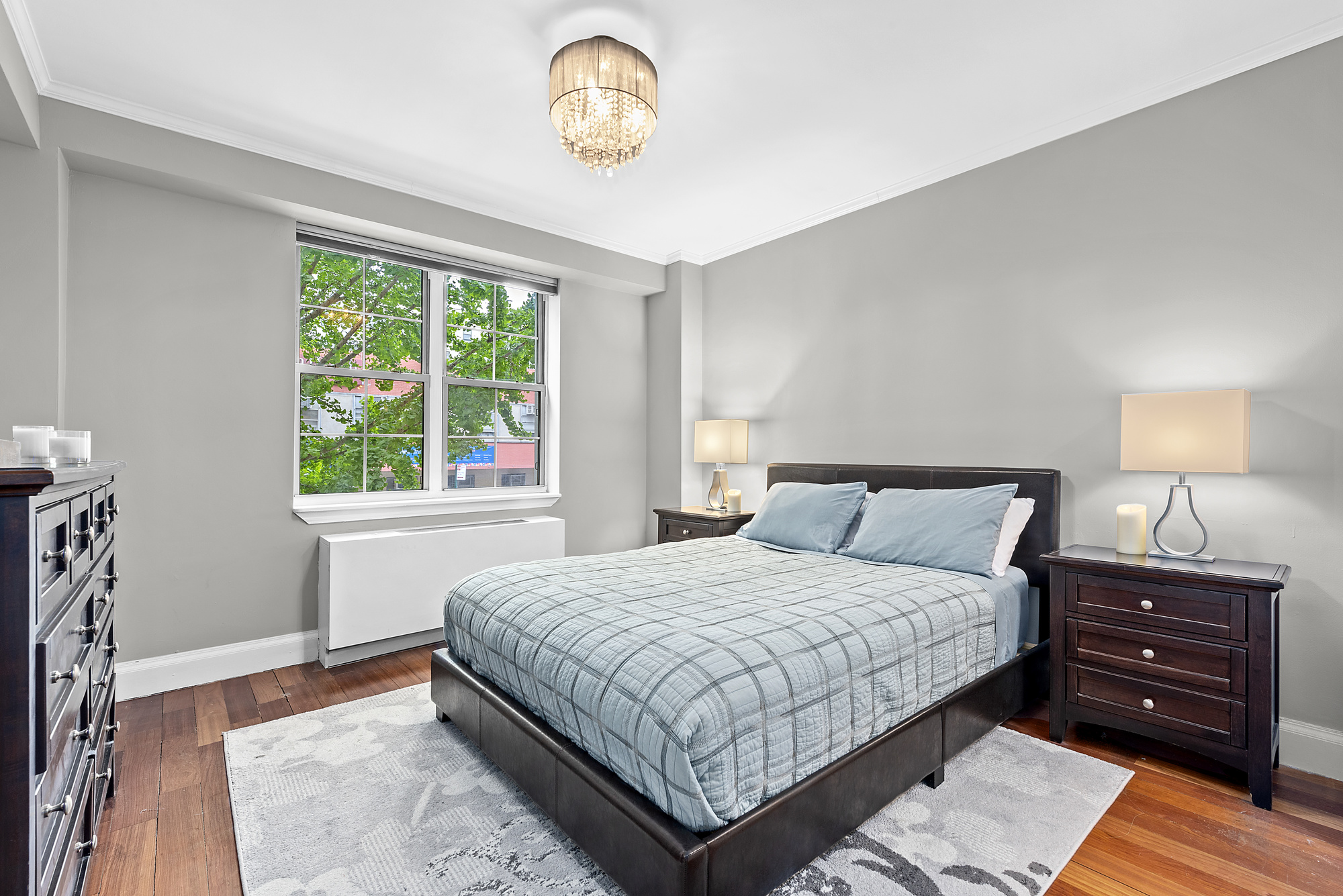 163 St Nicholas Avenue, Unit 2J Manhattan, NY 10026 - Photo 4 of 13 a bedroom with a bed and a window