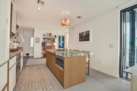 a kitchen with stainless steel appliances granite countertop a stove and a refrigerator