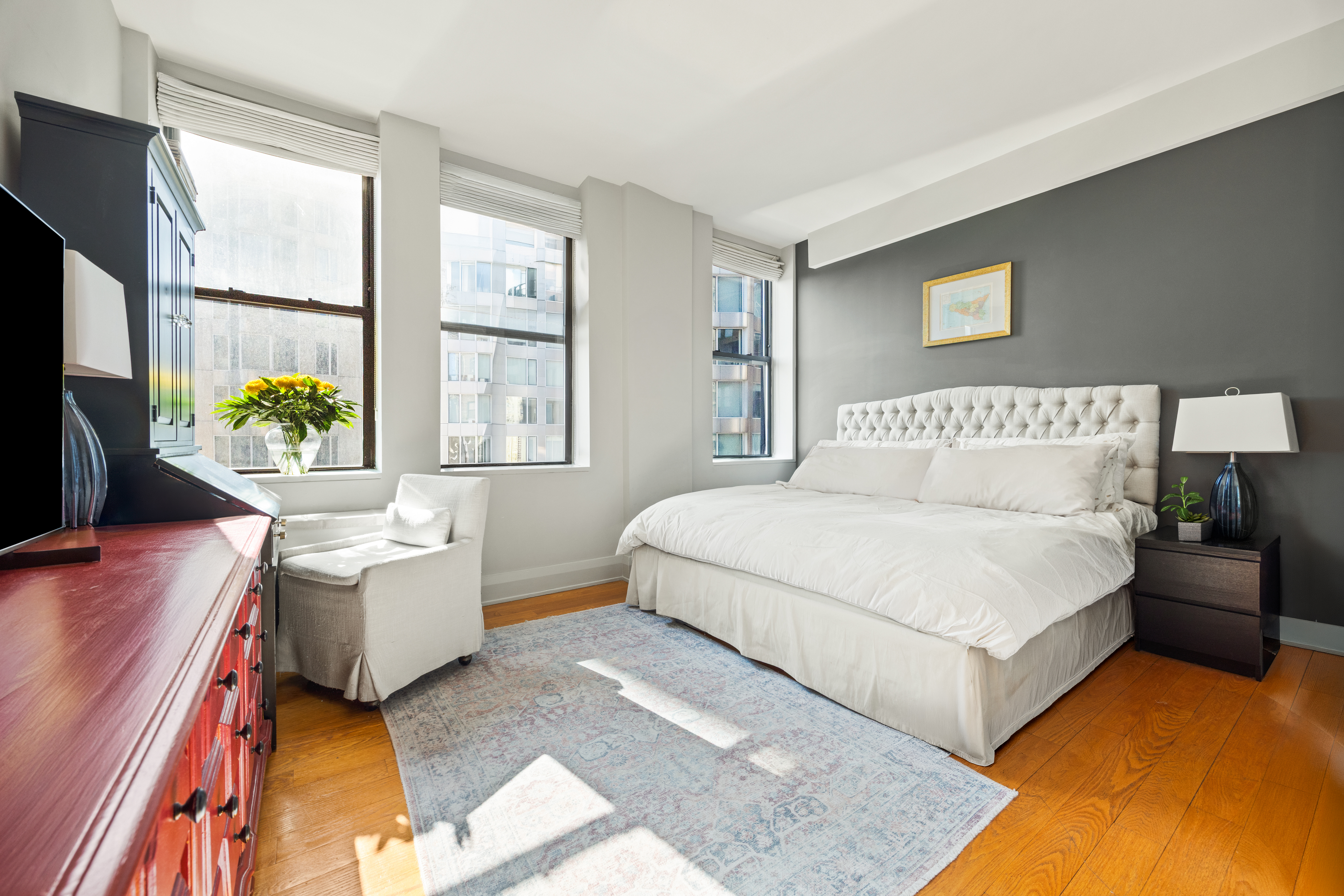 150 Nassau Street, Unit 17D Manhattan, NY 10038 - Photo 5 of 16 a bedroom with a bed couch and a window