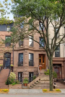 front view of a house with a tree