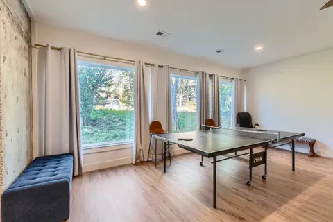 a view of a workspace with furniture and a window