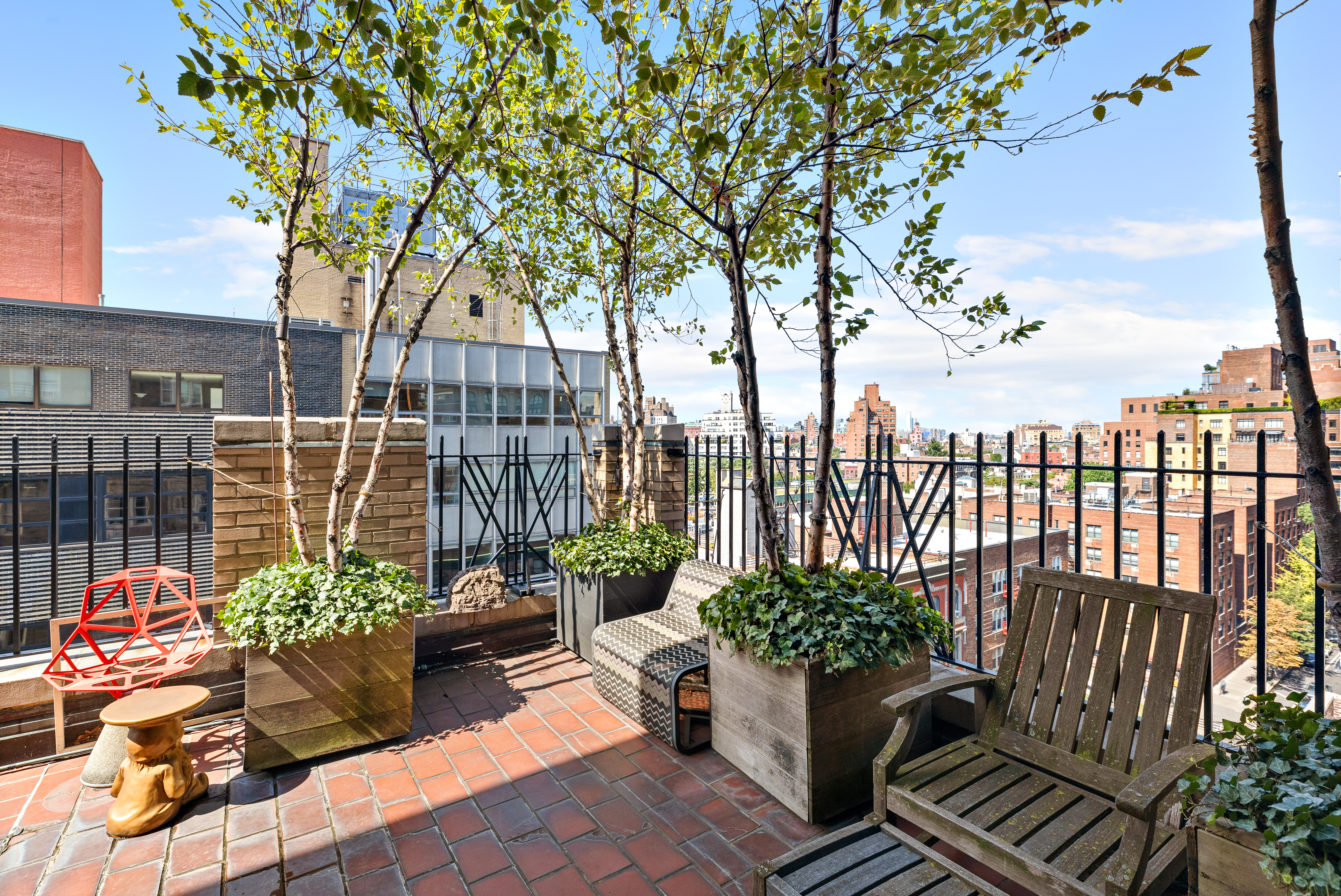 59 West 12th Street, Unit 11C Manhattan, NY 10011 - Photo 8 of 10 a view of a balcony with chairs potted plants and large tree