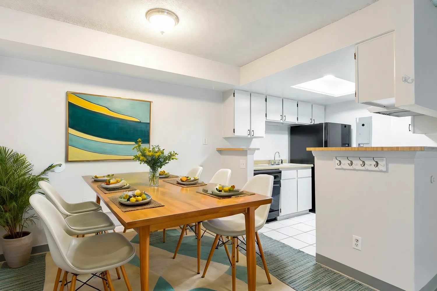 a kitchen with a table and chairs in it