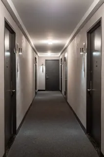 a view of a hallway with workspace and a window