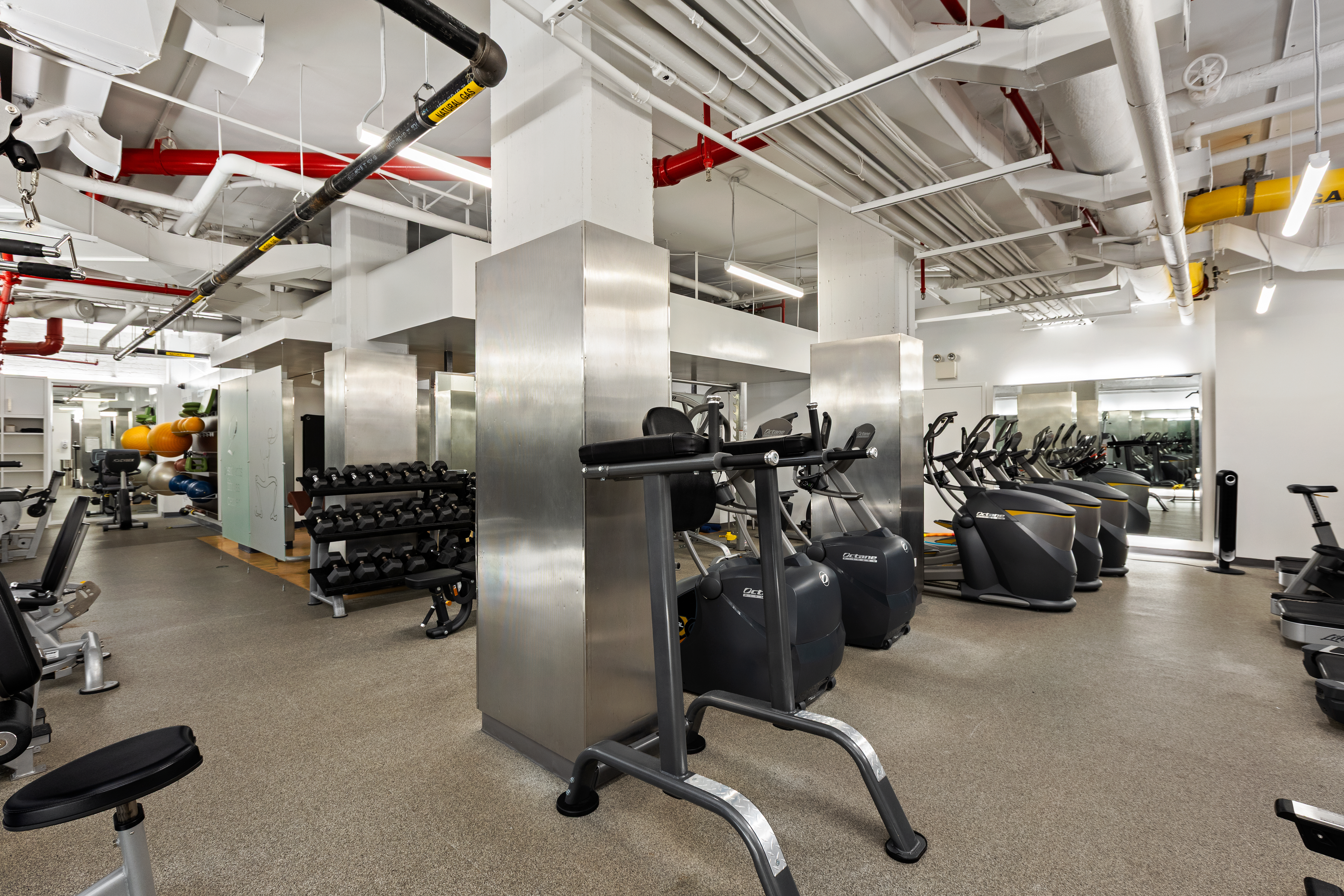 2 5th Avenue, Unit 5F Manhattan, NY 10011 - Photo 7 of 9 a gym room with lots of gym equipment