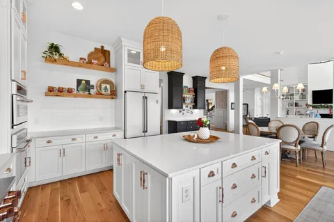 a spacious bedroom with a bed couch and window