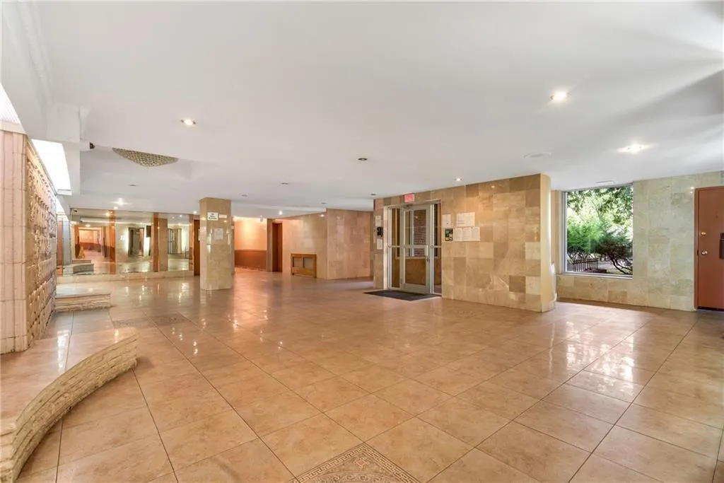 a view of interior space with furniture and floor to ceiling window