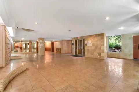 a view of interior space with furniture and floor to ceiling window