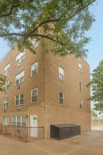 a brick building with a tree in front of it