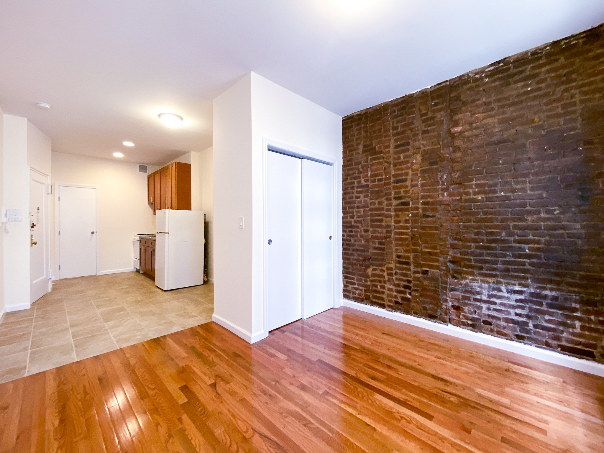 319 East 25th Street, Unit 3C Manhattan, NY 10010 - Photo 4 of 12 a view of empty room with wooden floor