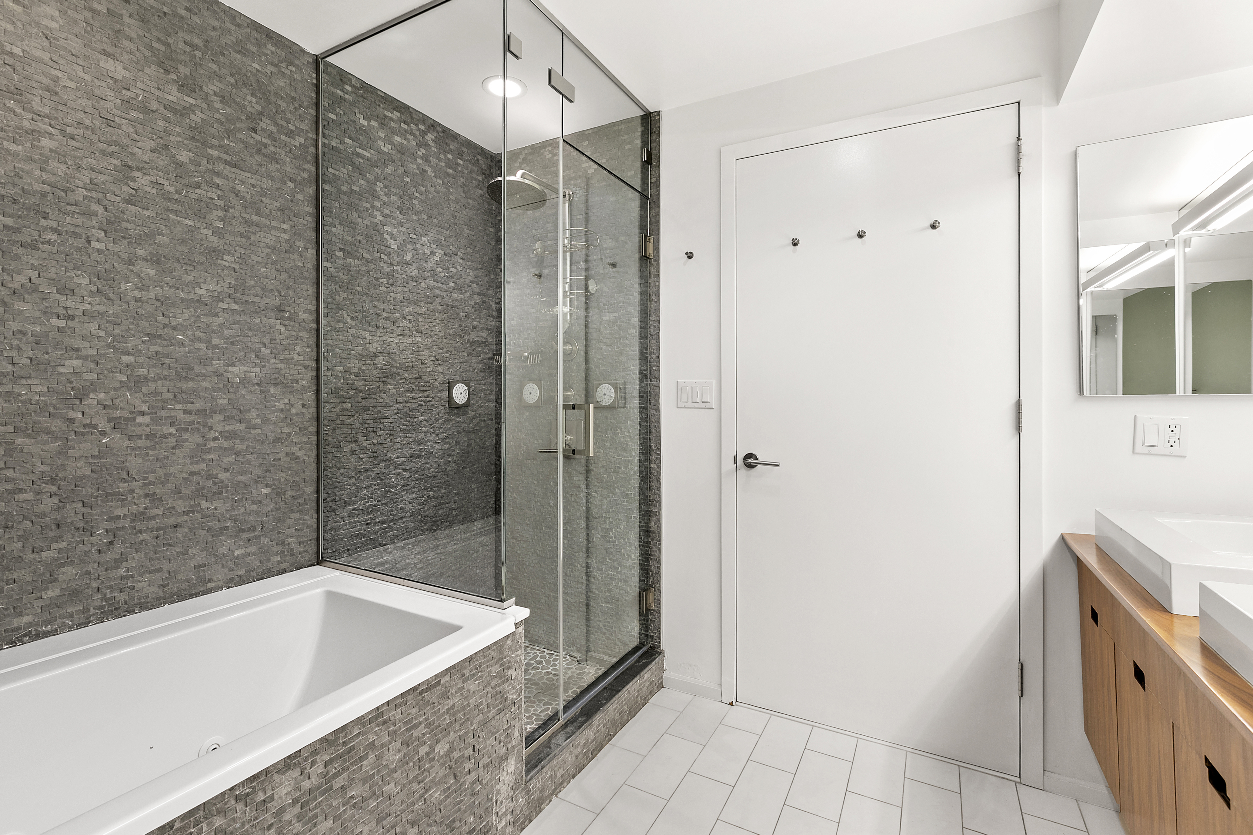 15 West 17th Street, Unit 6 Manhattan, NY 10011 - Photo 7 of 9 a bathroom with a bathtub and a shower
