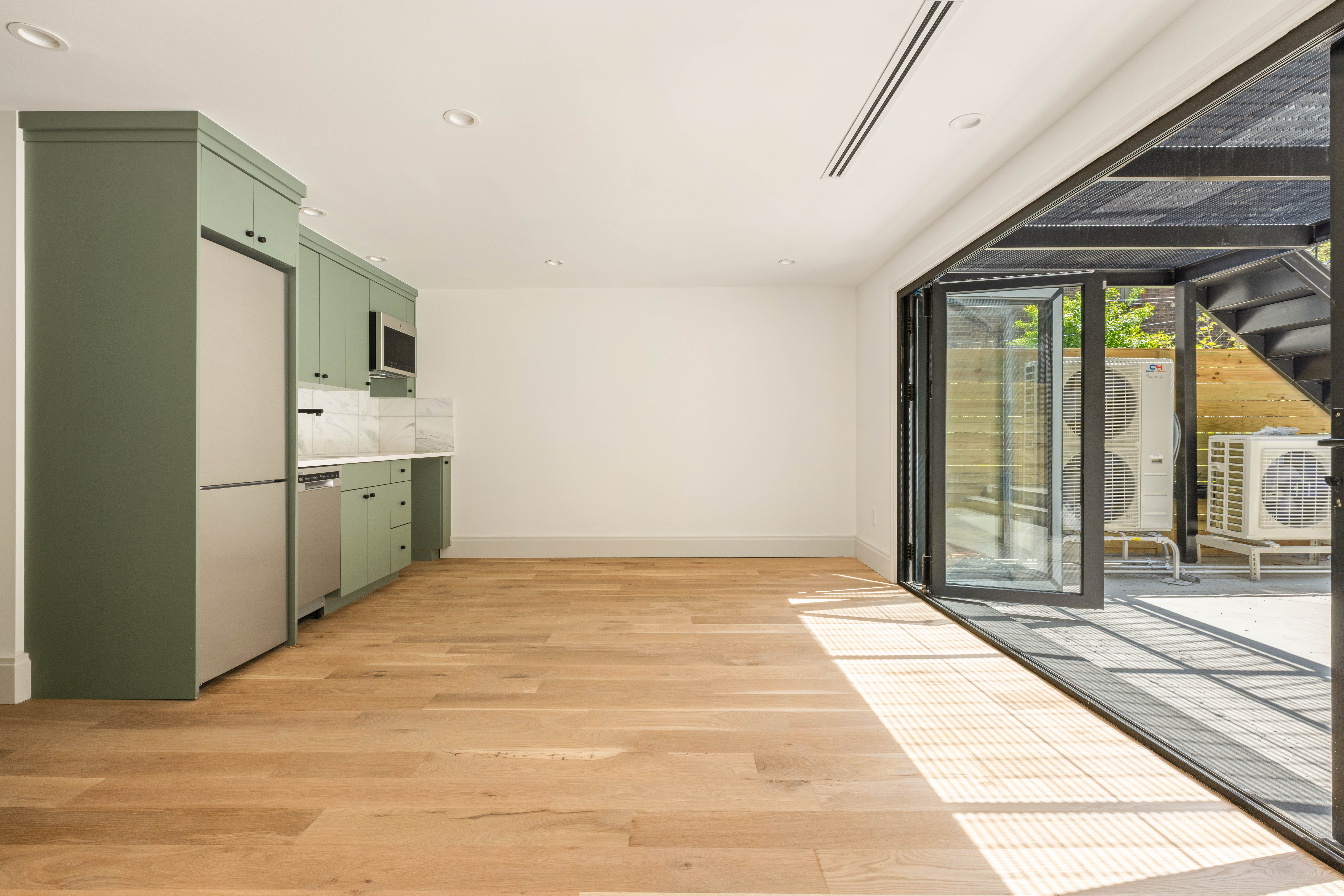 196 Monroe Street Brooklyn, NY 11216 - Photo 17 of 22 a view of an empty room with a window