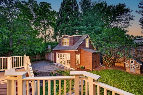 a front view of a house with a yard and outdoor seating