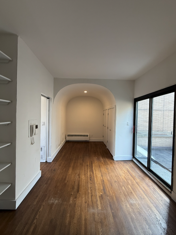 455 Park Avenue South, Unit PH1 Manhattan, NY 10016 - Photo 9 of 17 an empty room with wooden floor and windows