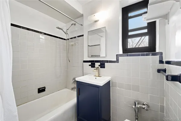a bathroom with a sink a mirror and a bathtub