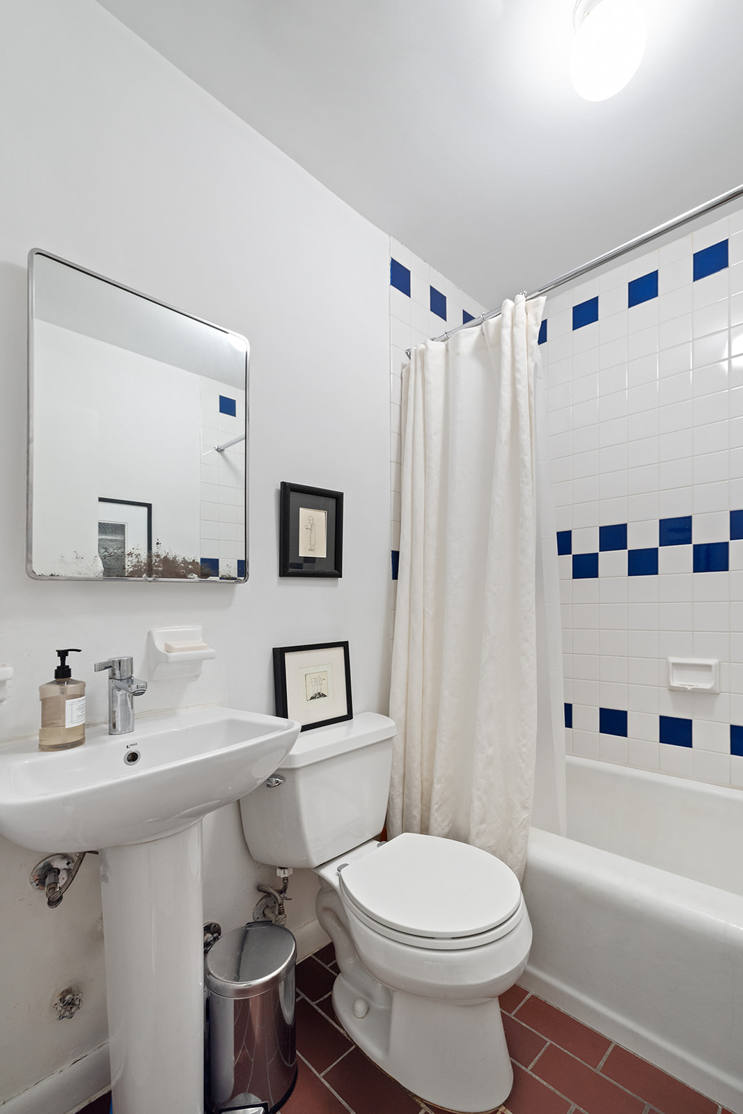 260 West 10th Street, Unit 1E Manhattan, NY 10014 - Photo 5 of 9 a bathroom with a sink toilet and shower