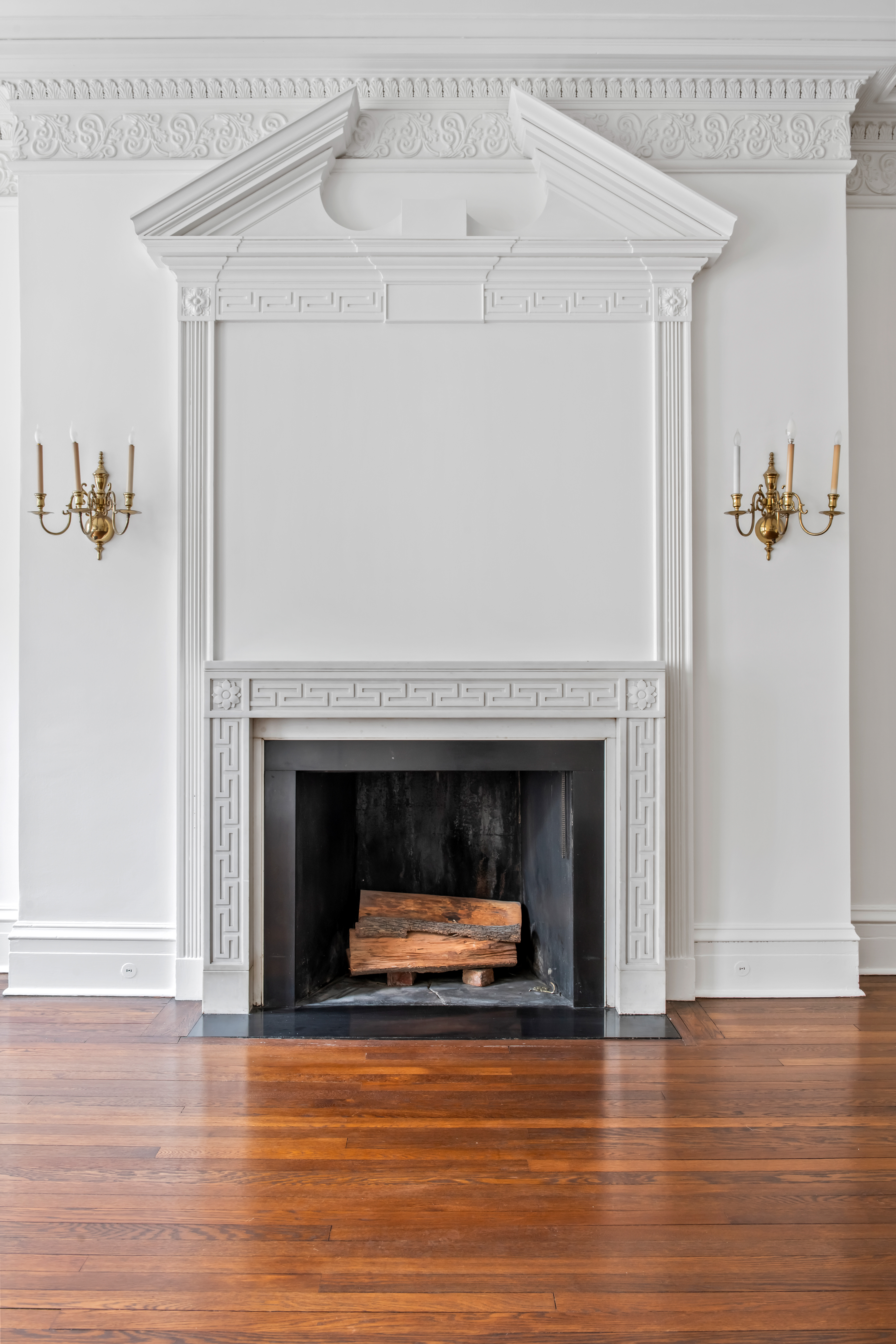 155 East 70th Street Manhattan, NY 10021 - Photo 24 of 27 a living room with a fireplace and a wooden floor