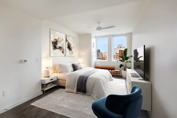 a bedroom with bed and a flat screen tv