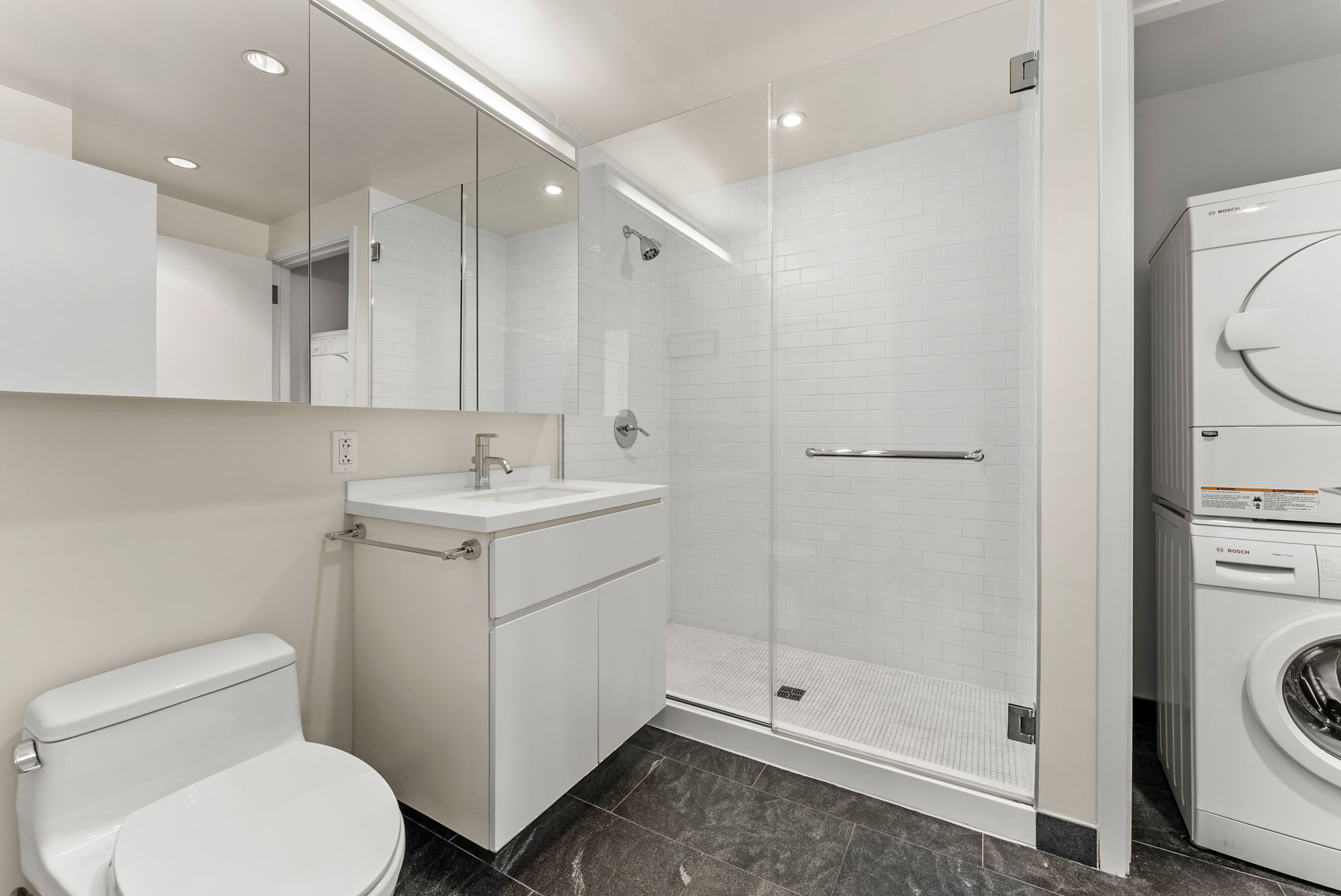 425 West 53rd Street, Unit 416 Manhattan, NY 10019 - Photo 13 of 19 a bathroom with a toilet sink and a shower