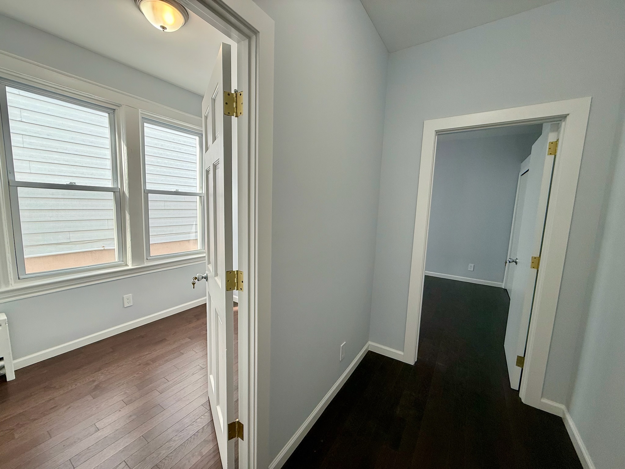 1675 85th Street, Unit 1F Brooklyn, NY 11214 - Photo 4 of 7 an entryway with wooden floor and windows