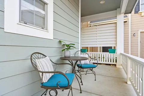 a balcony with table and chairs