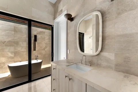 a bathroom with a double vanity sink and a mirror