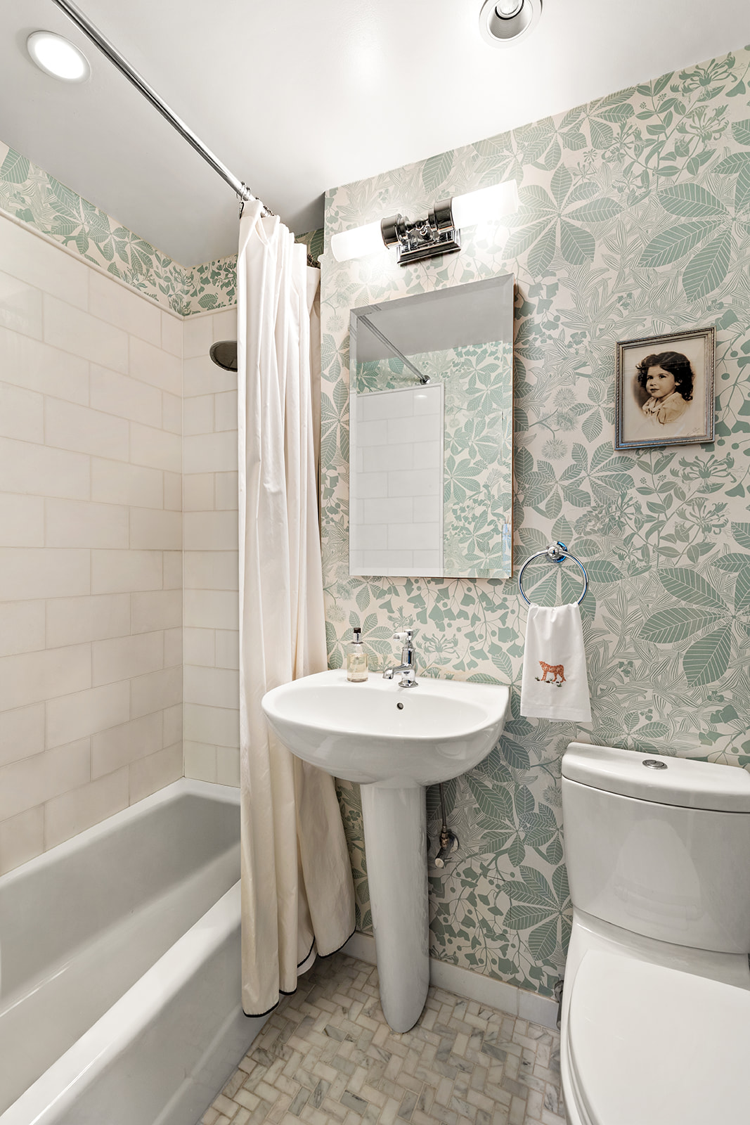 30 East 9th Street, Unit 5LL Manhattan, NY 10003 - Photo 8 of 10 a bathroom with a sink a toilet and shower