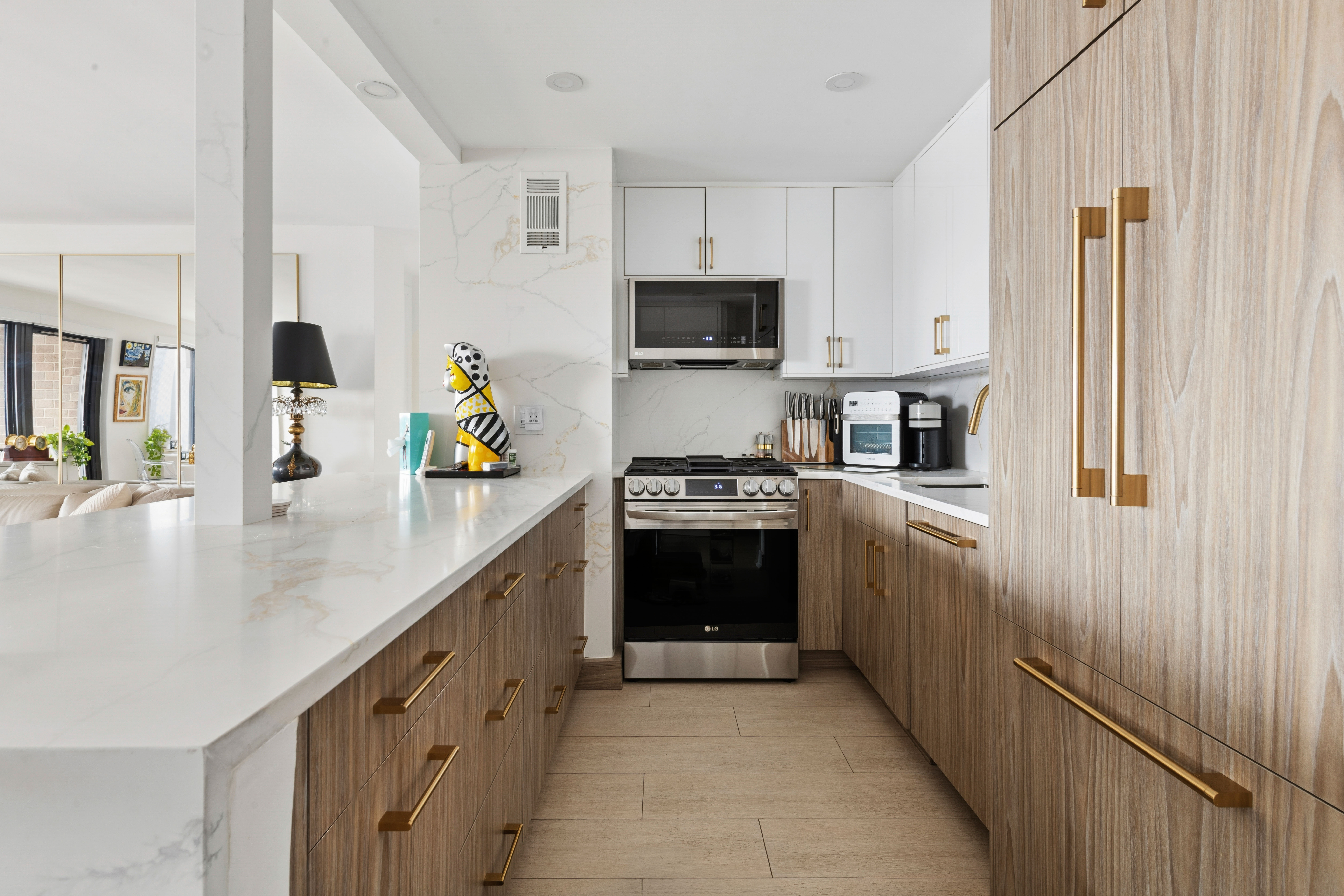 100 Beekman Street, Unit 26D Manhattan, NY 10038 - Photo 4 of 9 a kitchen with stainless steel appliances a sink a stove top oven a chimney and cabinets