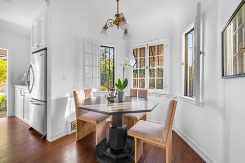 a kitchen with stainless steel appliances granite countertop a stove and white cabinets