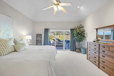a spacious bedroom with a bed and a dresser