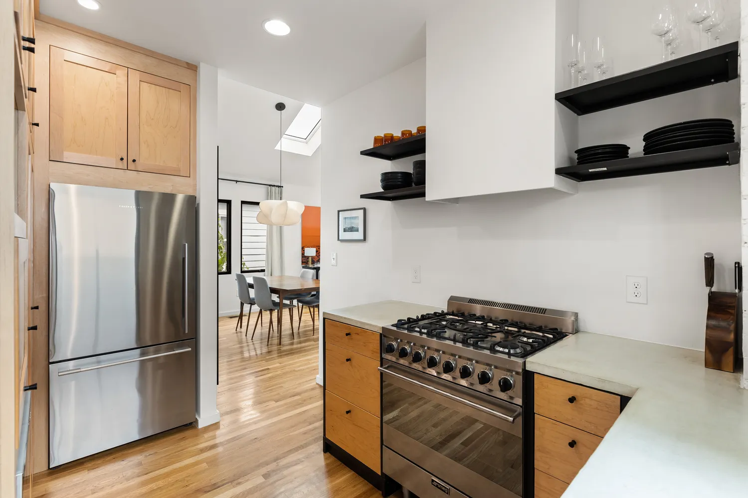 a kitchen with stainless steel appliances granite countertop a refrigerator and a stove top oven