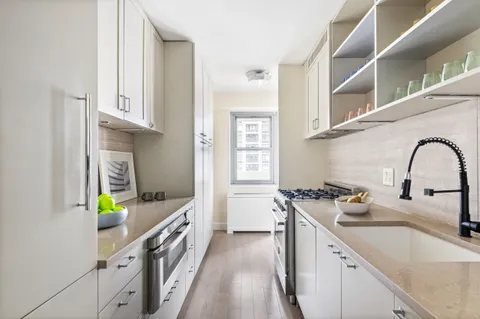 a kitchen with stainless steel appliances granite countertop a sink and a stove