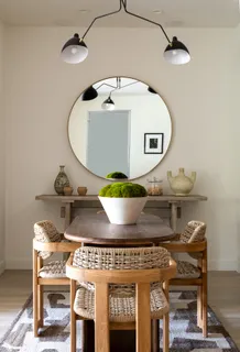 a living room with furniture a mirror and a table