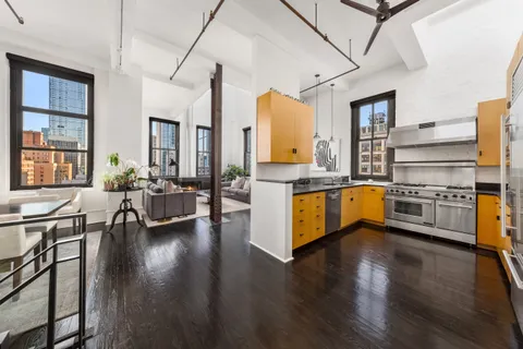 a kitchen with sink cabinets and wooden floor