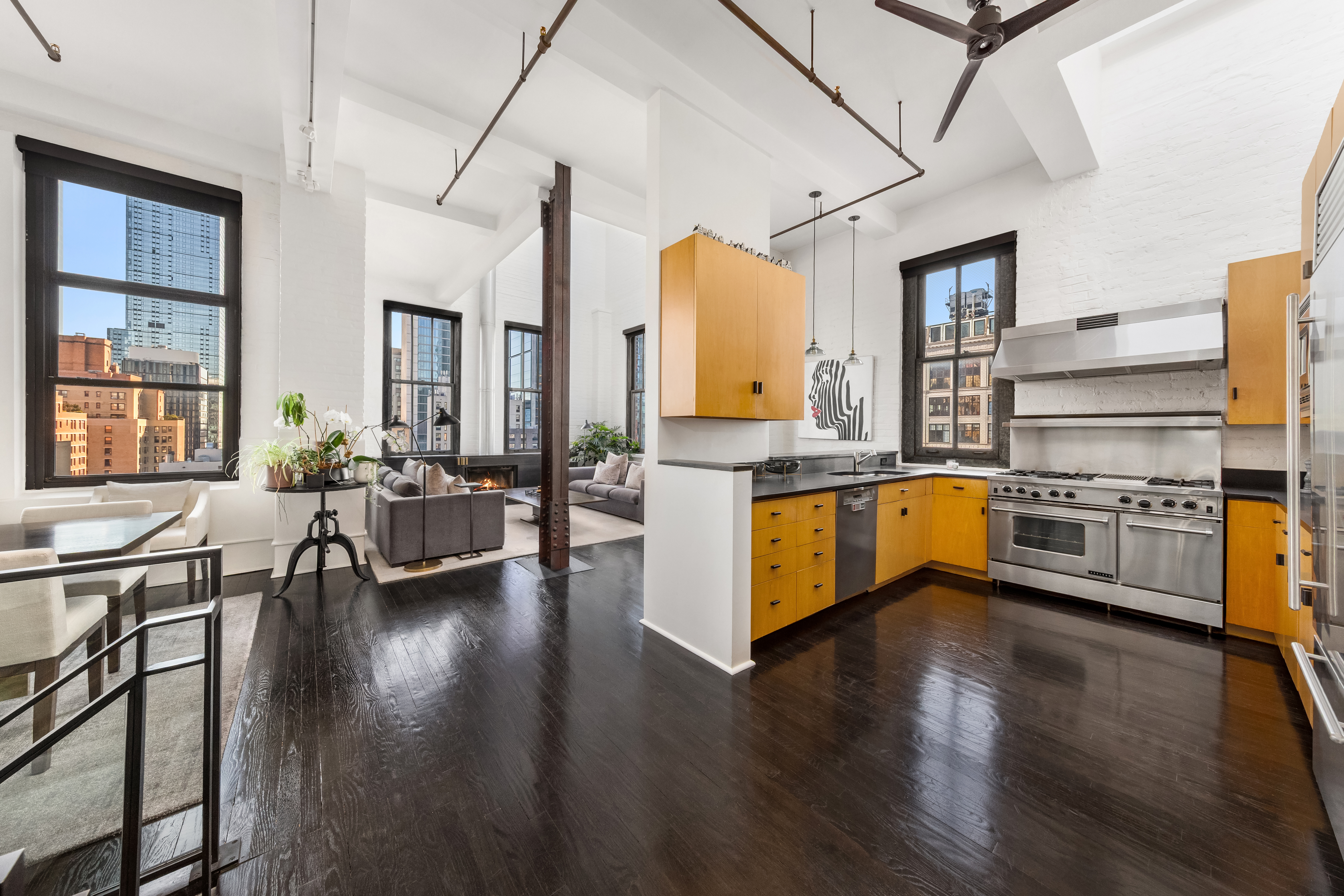 448 West 37th Street, Unit 11G/12G Manhattan, NY 10018 - Photo 3 of 17 a kitchen with sink cabinets and wooden floor