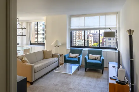 a living room with furniture and a large window